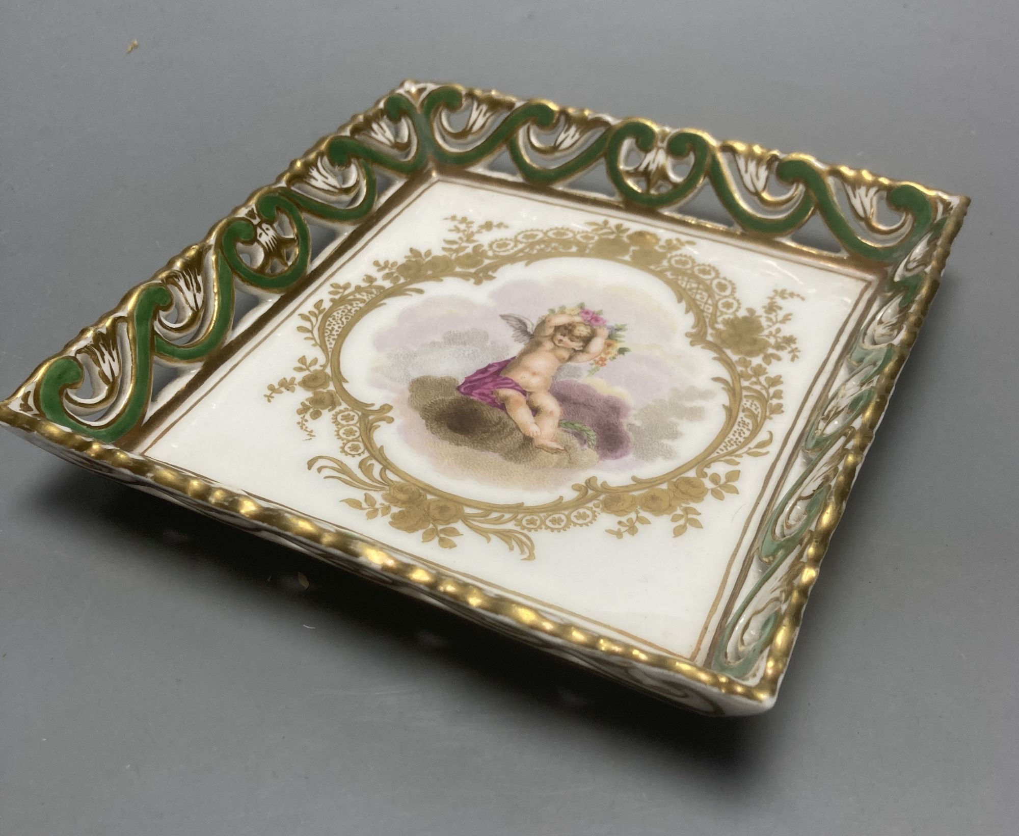 A Sevres square putti decorated dish, 15cm sq.